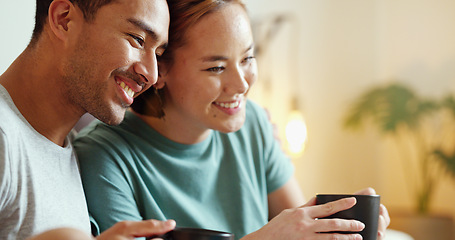 Image showing Happy, coffee and laughing asian couple bonding and having fun spending time together at home. Comic, funny and content man and woman drinking tea enjoying free time at home and laugh at comedy joke