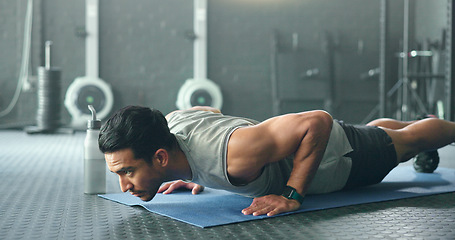 Image showing Fitness, man and pushups for muscle, exercise or training workout for strength or power at the gym. Athletic male in sport exercising lifting body with arms on the floor for strong muscles indoors