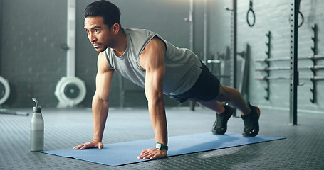 Image showing Fitness, man and pushups for muscle, exercise or training workout for strength or power at the gym. Athletic male in sport exercising lifting body with arms on the floor for strong muscles indoors