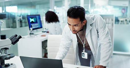 Image showing Scientist, research on laptop and tablet for laboratory test, DNA analysis and results in medical study at night. Serious man with science biotechnology, digital software and a computer for solution