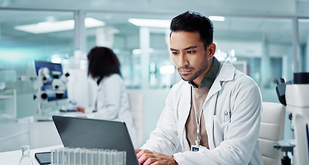 Image showing Tablet, scientist and typing on laptop in laboratory, healthcare and online research for medicine with analysis. Asian expert, computer and reading on clinical trials and information for innovation