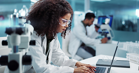 Image showing Scientist, woman and microscope with computer for laboratory research, test and DNA investigation at night. Professional doctor or science expert with lens check, laptop and particles for inspection