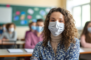 Image showing Woman Wearing Face Mask in Classroom, Ensuring Safety and Preventing the Spread of Illness