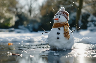 Image showing Snowman Standing in Water, Unusual Winter Scene in the Middle of a Pond