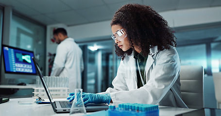 Image showing Scientist, woman and typing on laptop with test tube for chemistry, research or experiment at lab. Science, computer and serious medical professional in development of cure, biotechnology or study