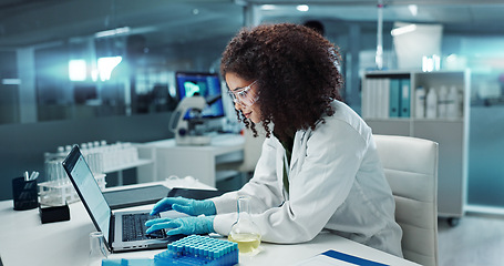 Image showing Scientist, woman and typing on laptop with test tube for chemistry, research or experiment at lab. Science, computer and serious medical professional in development of cure, biotechnology or study