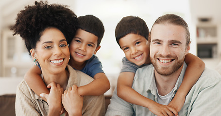 Image showing Love, hugging and face of a family on a sofa for relaxing, bonding and spending time together. Happy, smile and portrait of cute boy children embracing their young interracial parents at modern home.