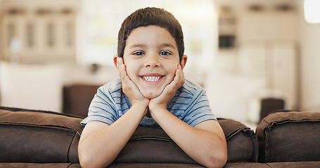 Image showing Happy, cute and face of a child on the sofa for playing, relax and weekend fun. Smile, youth and portrait of a little boy kid with an adorable expression, charming and on vacation on the couch