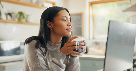 Image showing Laptop, coffee and freelance with a woman entrepreneur in the kitchen of her home for small business. Computer, report or email with a young female employee remote working on a startup from her house