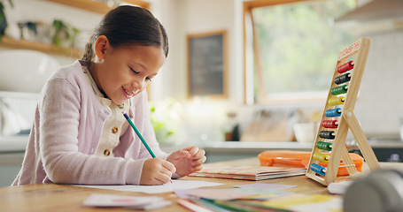 Image showing Education, writing and happy girl child in a kitchen with maths, homework or counting practice in her home. Learning, creative and female kid smile while drawing on a table for homeschool math lesson