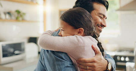 Image showing Children, father and daughter hug in the kitchen for love, trust or bonding together in their home. Family, smile and safety with a happy young man embracing his adorable girl child in their house