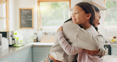 Image showing Love, mom and girl in a hug in family home with support, trust and bonding in kitchen or happy childhood memory of daughter. Smile, face and kid in embrace with mother, woman or together with mommy