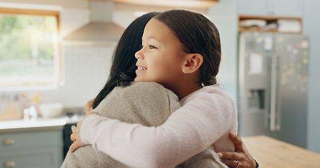 Image showing Love, mom and girl in a hug in family home with support, trust and bonding in kitchen or happy childhood memory of daughter. Smile, face and kid in embrace with mother, woman or together with mommy