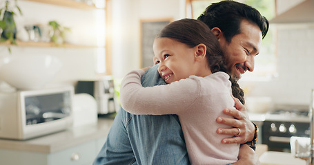 Image showing Family, father and daughter hug in the kitchen for love, trust or bonding together in their home. Kids, smile and safety with a happy young man embracing his adorable girl child in their house