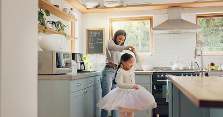 Image showing Dance, ballet and girl with mother in a kitchen together or mom support child and playing as a dancer or ballerina. Tutu skirt, mommy and woman dancing, bonding or spin with kid in house or home