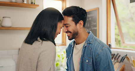 Image showing Love, hug and happy couple in a kitchen talking, together and intimate while bonding in their home. Embrace, romance and man with woman hugging, smile and sharing moment, conversation and laughing