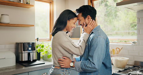 Image showing Hug, happy and couple in a kitchen bonding, intimate and talking in their home together with intimacy. Love, face and woman embrace man with smile, care and sharing romantic moment and conversation