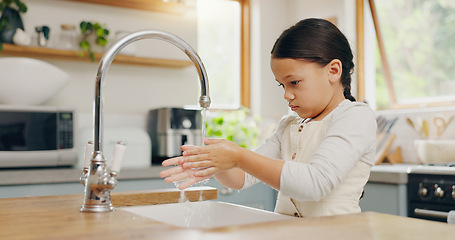 Image showing Water, washing hands and girl child in kitchen for hygiene, safety and responsibility in her home. Splash, cleaning and female kid at a sink for palm scrub, learning and care, bacteria or prevention