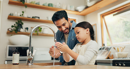 Image showing Girl washing her hands with her father in the kitchen for hygiene, health and wellness at home. Child learning to clean her skin with young dad with soap and water to prevent germs, dirt or bacteria.