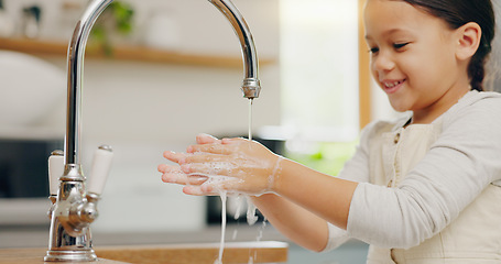 Image showing Washing hands, water and happy girl child in kitchen for hygiene, safety or responsibility at home. Smile, cleaning and female kid at a sink for palm scrub, learning and care, bacteria or prevention