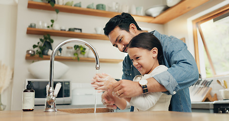 Image showing Girl washing her hands with her father in the kitchen for hygiene, health and wellness at home. Child learning to clean her skin with young dad with soap and water to prevent germs, dirt or bacteria.