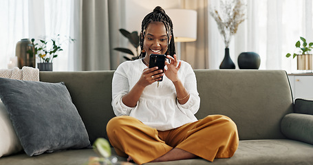 Image showing Home, funny and black woman on a sofa, cellphone and connection with social media, comedy post and laugh. African person, apartment or girl on couch, smartphone or mobile user with humor or typing