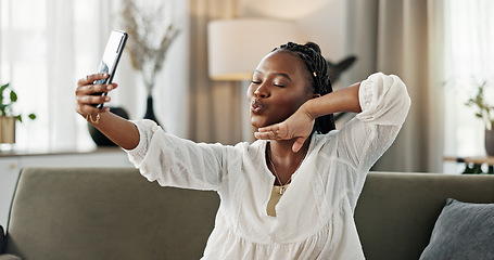 Image showing Smile, selfie and black woman with peace sign, funny face and relax on sofa in living room. V hand, picture and happy African person or influencer at home on couch on social media with tongue out