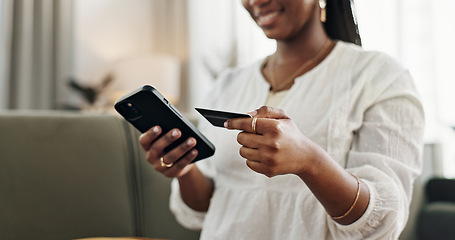 Image showing Hands, woman and credit card with smartphone on sofa for online shopping, payment and fintech at home. Closeup, mobile banking and finance for sales, password and code for ecommerce, money or savings