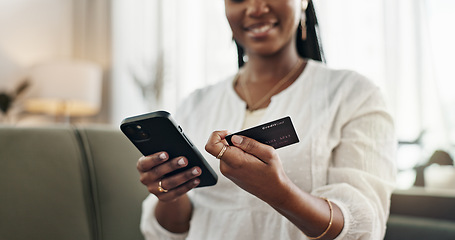 Image showing Hands, woman and credit card with smartphone on sofa for online shopping, payment and fintech at home. Closeup, mobile banking and finance for sales, password and code for ecommerce, money or savings