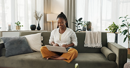 Image showing Black woman on sofa, smile and typing on laptop for remote work, social media or blog post research in home. Happy girl on couch with computer checking email, website or online chat in living room.