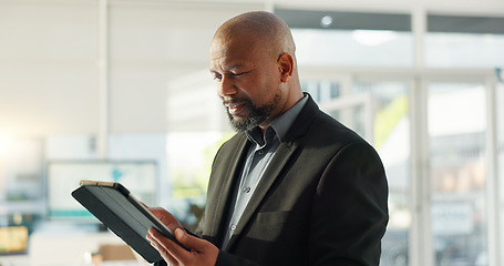 Image showing Business man, typing and tablet in office for online finance, accounting and investment software or research. Professional african person or investor for digital technology, company revenue or data