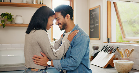 Image showing Love, hug and couple in a kitchen happy, together and intimate while bonding in their home. Embrace, romance and man with woman hugging, smile and sharing moment of trust, care or soulmate connection