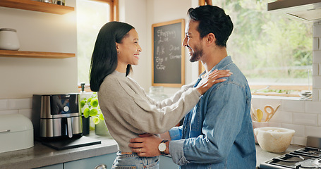 Image showing Hug, happy and couple in a kitchen bonding, intimate and talking in their home together with intimacy. Love, face and woman embrace man with smile, care and sharing romantic moment and conversation