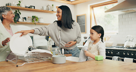 Image showing Child cleaning the kitchen with her grandmother and mother while bonding, talking and laughing. Happy, smile and girl kid washing the dishes with her young mom and senior woman in their family home.