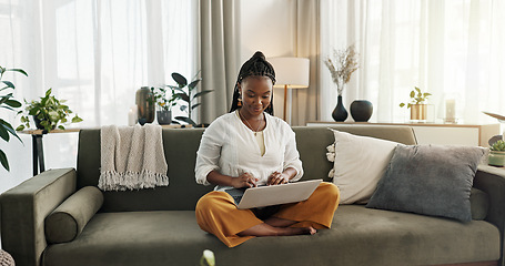 Image showing Black woman on sofa, smile and typing on laptop for remote work, social media or blog post research in home. Happy girl on couch with computer checking email, website or online chat in living room.