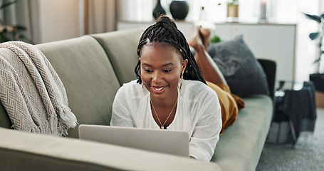 Image showing Black woman on sofa, relax or typing on laptop for remote work, social media or blog post research with smile in home. Happy girl on sofa with computer checking email, website or online chat in house