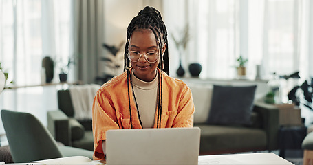 Image showing Black woman, typing in home office and laptop for remote work, social media or blog research in apartment. Freelance girl at desk with computer writing email, website post and online chat in house.