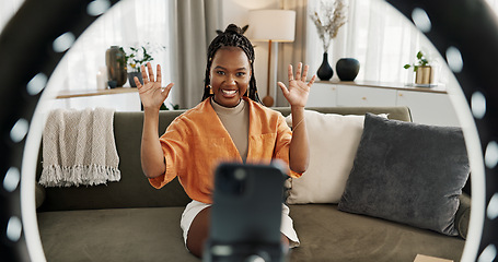 Image showing Wave, live streaming and happy black woman with box or product in home living room. Hello, influencer and person with package, record video on social media and content creation, ring light and phone