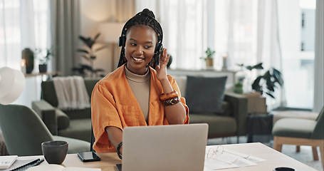 Image showing Black woman, headset in home office with laptop and phone call, remote work and crm in apartment. Virtual assistant at desk with computer, typing and conversation for advice, online chat and support