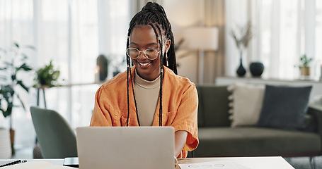 Image showing Black woman, typing in home office and laptop for research in remote work, social media or blog in apartment. Freelance girl at desk with computer writing email, website post and online chat in house