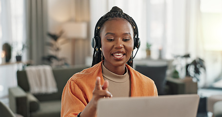 Image showing Black woman, headset with laptop and phone call, virtual assistant or crm in home office. Remote work girl at desk with computer, typing and conversation for advice, online chat and help in apartment