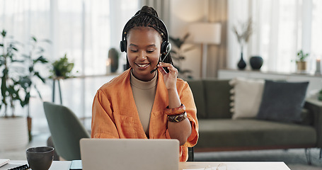 Image showing Black woman, headset in home office with laptop and phone call, remote work and crm in apartment. Virtual assistant at desk with computer, typing and conversation for advice, online chat and support