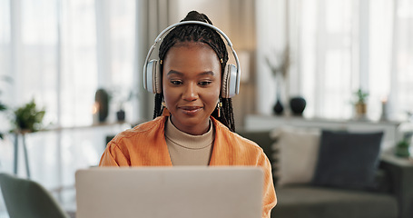 Image showing Laptop, headphones and young woman in living room listening to music, playlist or album in modern apartment. Technology, smile and young African person streaming song on computer in lounge at home.