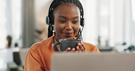 Image showing Black woman, headset and coffee in home office with laptop and remote work and break in apartment. Virtual assistant at desk with computer, drink and relax with freelancer, consultant or crm agent.