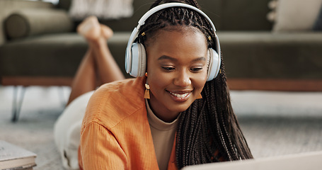 Image showing Home, smile and black woman with a headphones, streaming music or sound in a living room. African person on a sofa, apartment or girl with headset, listening to audio or relax with happiness or song