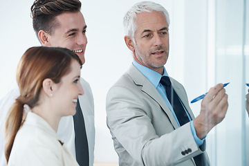 Image showing Glass wall, writing and business people in a meeting, coaching and brainstorming with financial planning. Project, teamwork and manager with employees and teaching with conversation and cooperation