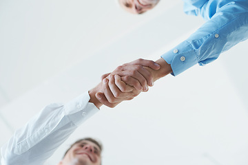 Image showing Low angle, business people and handshake with partnership, teamwork and agreement. Staff, shaking hands and thank you with mockup space and cooperation for a project or collaboration with recruitment