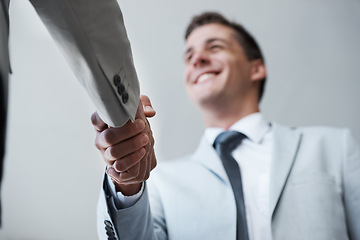 Image showing Low angle, businessman and shaking hands with partner, colleague and smile for deal or promotion. Man, consult and hand for contract agreement, interview and advice for agency and office partnership