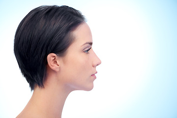 Image showing Beauty, skincare and profile of woman in studio with health, cosmetic and facial routine. Wellness, glow and young female person with face dermatology treatment by blue background with mockup space.