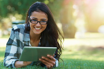 Image showing College, woman and portrait with tablet in park for research, project or learning outdoor on campus. University, student and girl streaming online with ebook, education or studying on grass in garden